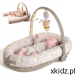 Taf Toys Przytulny Kokon 2w1 – gniazdko z pałąkiem i muzycznym misiem