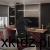 Czarny fotel Force 5.7 Black przy biurku z monitorem w ciemnym wnętrzu